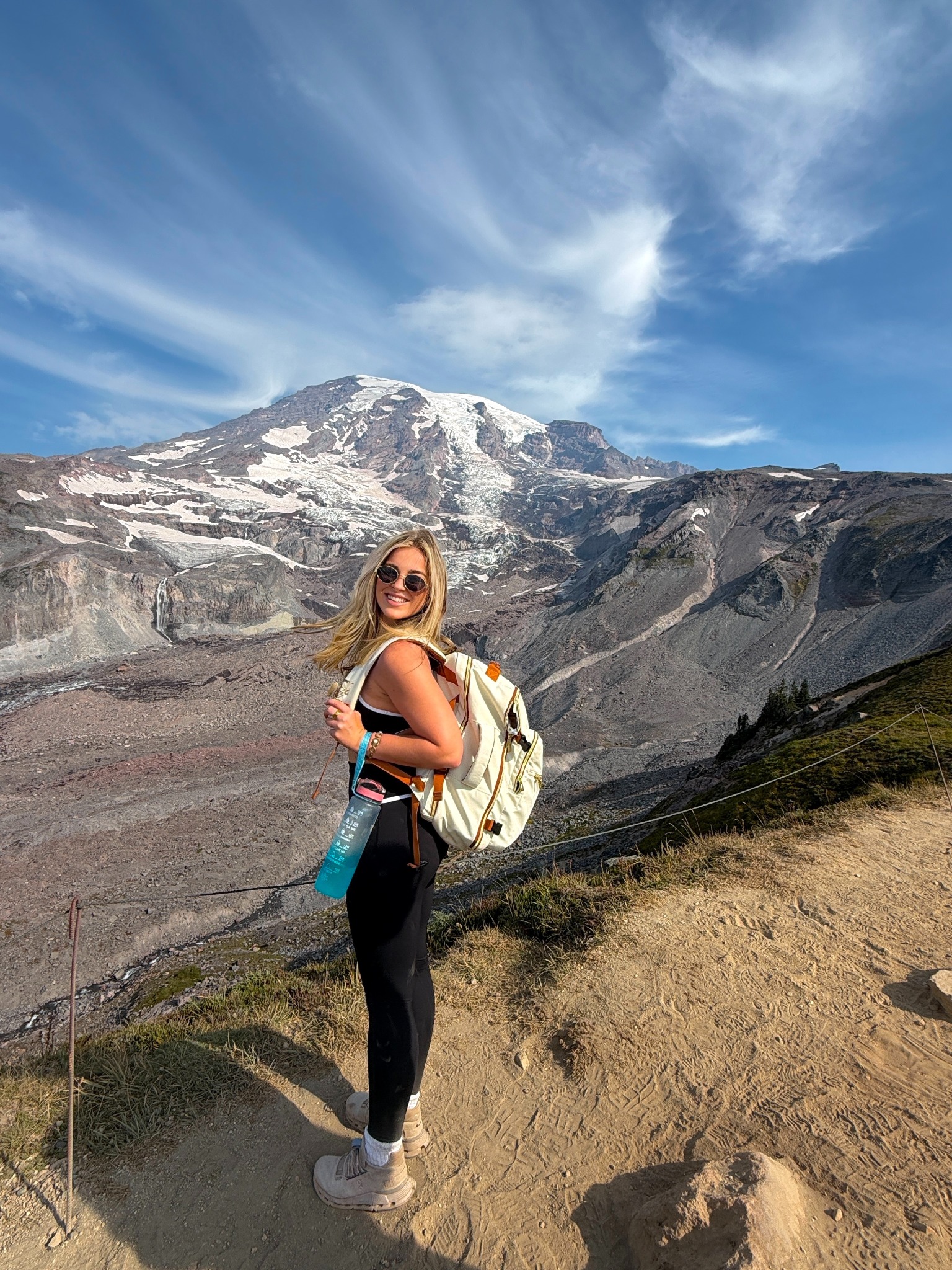 Kaylyn smiling on a mountain hike